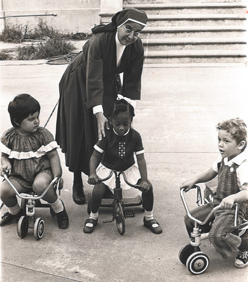 An archive photo dated October 8, 1971 from The Voice, the former newspaper of the Archdiocese of Miami, shows Sister Hilda Alonso, a Daughter of Charity of St. Vincent de Paul, supervising children at play at Centro Hispano Catolico's nursery. The Daughters of Charity celebrated 50 years since they arrived in Miami at a Mass celebrated by Archbishop Thomas Wenski and other priests at St. Mary Cathedral on Aug. 14, 2021.