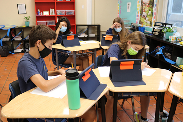 Sixth graders work on an assignment using Apple technology during classes at St. Anthony. Rocco Jean, a student in class, said that he likes using his Apple iPad. "It is not complicated," he said.