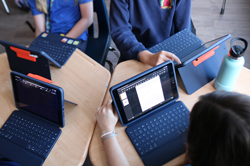 Students at St. Anthony School work in groups using their Apple iPads and applications to help them learn in new and creative ways.