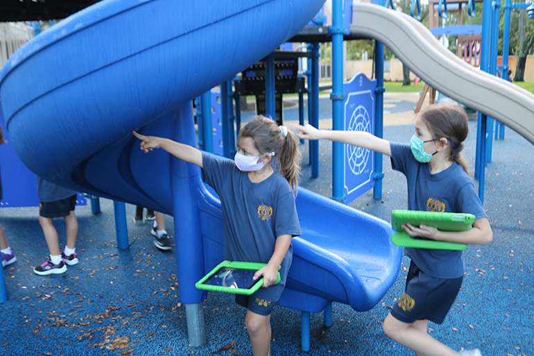 First grade students at St. Anthony School take their Apple iPads outside the classroom for lessons in a fun and creative way.