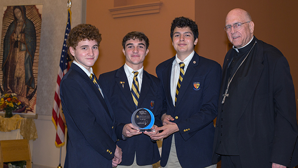 Belen students Andres Cueto, 16, Aidan Girado, 18, and Jose Muniz, 16, receive a Walking with Moms award from Archbishop Joseph H. Naumann, chairman of the U.S. bishops' Committee on Pro-Life Activities, during the second night of the Congreso Pro Vida, Oct. 30, 2021.