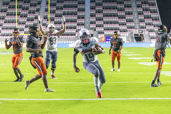 Cardinal Gibbons running back Kamari Moulton (19) runs the ball in for the school's third and final touchdown during the Class 4A State Championship game between Cardinal Gibbons and Cocoa Beach at DRV PNK Stadium in Fort Lauderdale, Dec. 16, 2021. Moulton scored back-to-back touchdowns to give Gibbons the championship with a final score of 21 to 19.