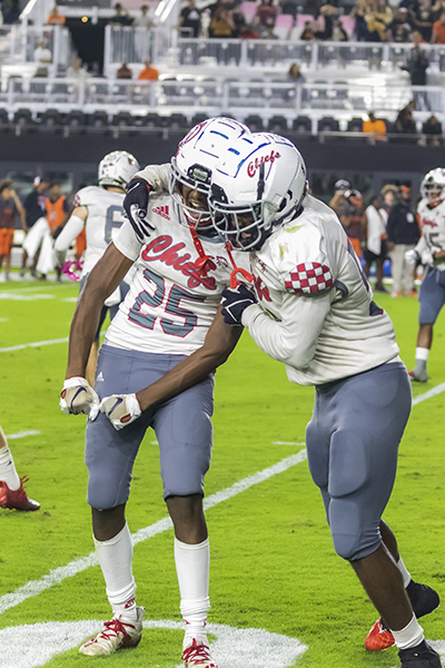 Right, Cardinal Gibbons defensive end Christopher Williams (58), celebrates with teammate defensive back Casey Etienne (25) during the fourth quarter of the Class 4A State Championship game between Cardinal Gibbons and Cocoa Beach at DRV PNK Stadium in Fort Lauderdale, Dec. 16, 2021.