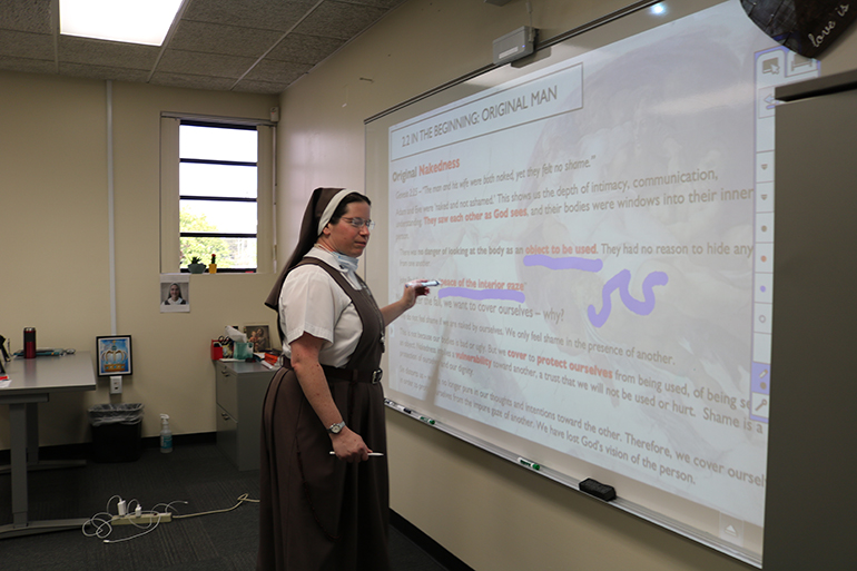 Sister Bethany Miller, a member of the Servants of the Pierced Hears of Jesus and Mary, uses a touch screen, one of several Apple products that help her better teach her theology classes at Cardinal Gibbons High School in Fort Lauderdale.