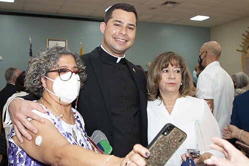 Deacon Enzo Rosario Prendes poses with well-wishers after his Dec. 18, 2021 ordination. The deaconate is the final step in his journey to the priesthood.