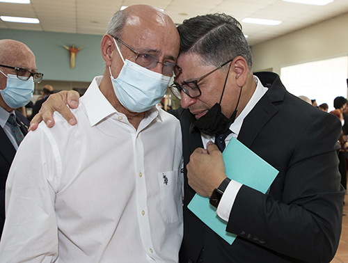 Deacon Erick Cinco, right, shares an emotional moment with Deacon Jose Manuel Gordillo, whom he called "the Lord's instrument for me to say yes" to the deaconate.