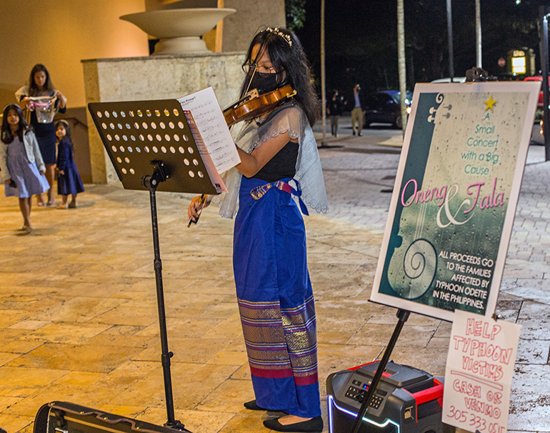 Filipino-American Oneng Redila plays the violin before Mass Dec. 23, 2021 at St. Bonaventure Church in Davie, to help victims of a recent typhoon that struck the Philippines. Tala Salao, violinist, not pictured here, also played the violin as part of a duet.