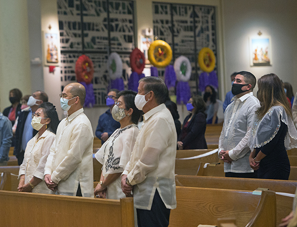 Filipino Apostolate members pray at St. Bonaventure Church in Davie on the final night of Simbang Gabi, the traditional Christmas novena, Dec. 23, 2021.