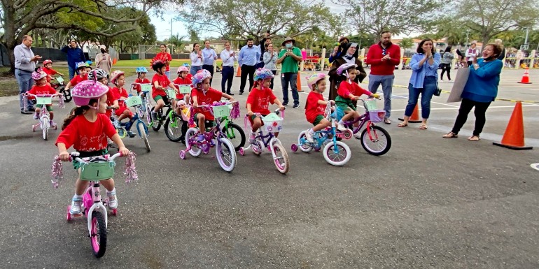 Parents, teachers, student and St. Theresa administrators cheer for the young trikers.