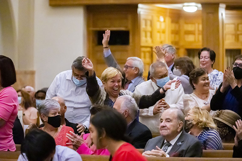 Couples married 40 to 49 years stand to be recognized and cheer during the annual wedding anniversary Mass at St. Mary Cathedral, Feb. 12, 2022.