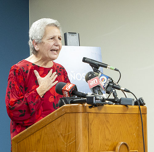 Elena Muller Garcia, a Pedro Pan who retired after 25 years working for Catholic Charities in the Diocese of Palm Beach, speaks up for today's unaccompanied minors during the press conference. "Although their circumstances are different, they have the same needs, or maybe more needs, than I did 62 years ago. Governor DeSantis, welcome these children, Do not close the doors of this great state of Florida on them.”