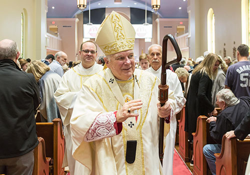 Archbishop Thomas Wenski processes out of St. Michael the Archangel Church in Fernandina Beach after celebrating Mass for the 150th anniversary of the parish, Feb. 20, 2022.