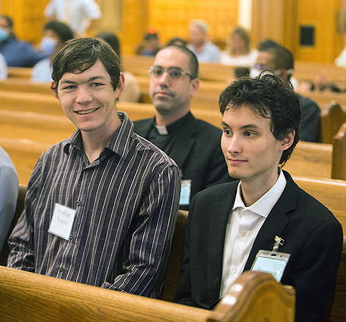 Catechumen Jonathan Rogers, left, sits with his sponsor, Sean Festa, during the Rite of Election ceremony held March 6, 2022 at St. Mary Cathedral. Both are University of Miami students from St. Augustine Church and Catholic Student Center.