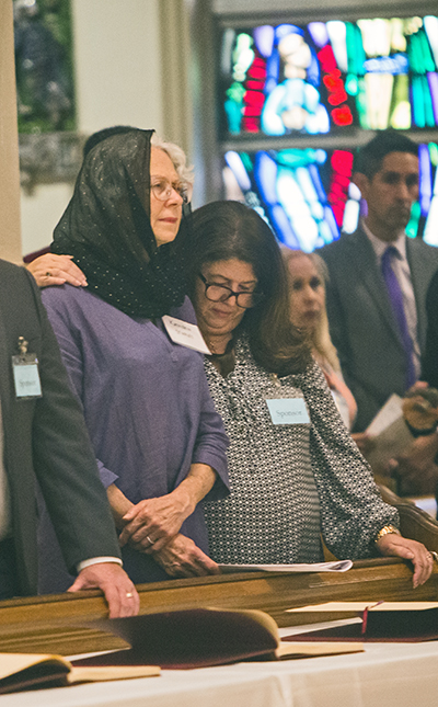 Sponsor Nancy Fleitas places her hand on the shoulder of Kathleen Staples, both from Little Flower Church, Coral Gables, during the Rite of Election ceremony held March 6, 2022 at St. Mary Cathedral.
