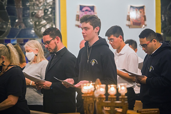 Father Bryan Garcia, far left, vice-rector and dean of seminarians at St. John Vianney College Seminary in Miami, joins seminarians, from left, Adam Perez, Jared Jackson and Didier Montoya in reciting prayers during the Moleben to the Mother of God held March 9, 2022 at Assumption of the Blessed Virgin Mary Ukrainian Catholic Church in Miami. The church has been holding the nightly prayers for peace and an end to the war in Ukraine since Russia's invasion.