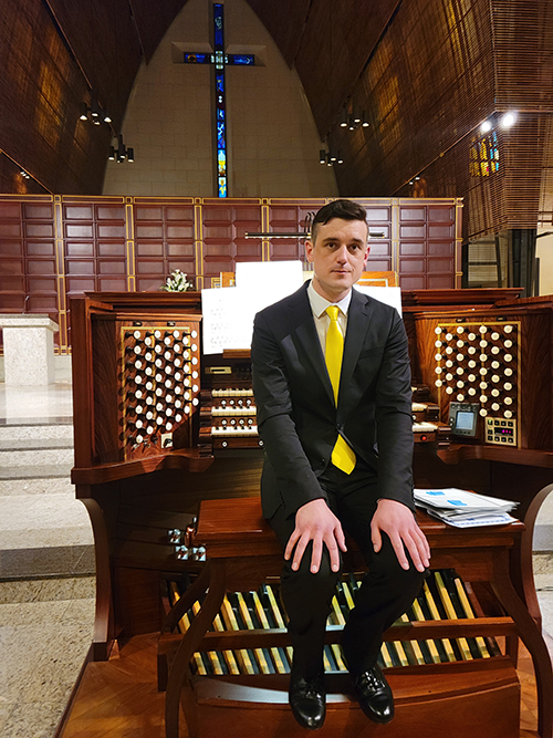 International and national award winning organist David Baskeyfield sits at the Frattelli Ruffatti organ console set at the foot of the altar at Epiphany Church in Miami. On Feb, 24, 2022, he played the first organ concert since the pandemic stopped all performances at the church.