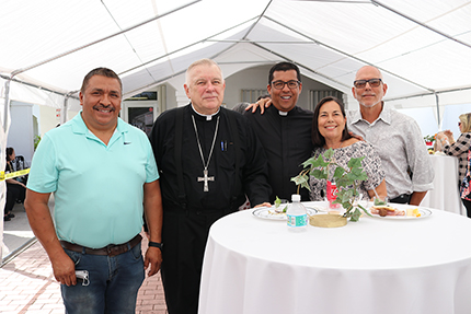 After the blessing of the new St. Joseph chapel at Prince of Peace in Miami, Archbishop Thomas Wenski poses with, from left, Rogelio Tenorio, who donated the labor for the chapel's construction; Father Giovanni Peña, pastor; and Nury Feeria and her husband, Jose Feito, who donated the design and the technical drawings for the new chapel.