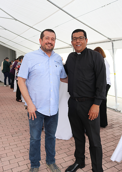 After the dedication ceremony for the new chapel of St. Joseph at Prince of Peace in Miami, Father Giovanni Peña, pastor, poses with Ivan Figueroa, who donated all the marble for the chapel and the church's sanctuary, which is currently being remodeled.