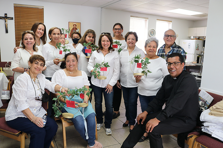 Members of Prince of Peace's women's Emmaus group and one member of the Forjando el Camino (Making a Way) group, pose with their pastor, Father Giovanni Peña, after the ceremony where the parish's new adoration chapel, dedicated to St. Joseph, was blessed on his feast day, March 19, 2022. The Emmaus women provided all the food for the reception that followed the blessing ceremony.