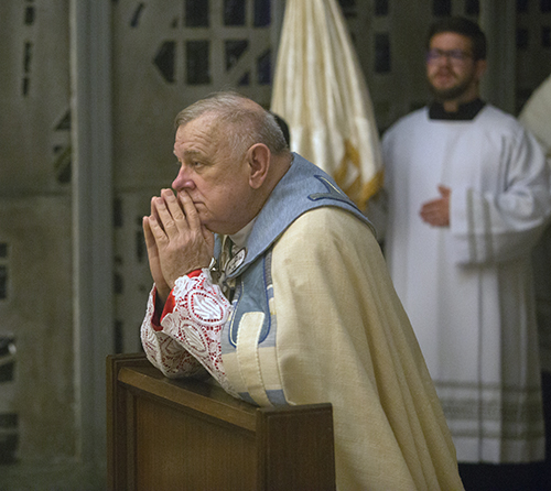 Archbishop Thomas Wenski prays before the Blessed Sacrament after placing it at the altar of repose at the conclusion of Holy Thursday Mass at St. Mary Cathedral, April 14, 2022.