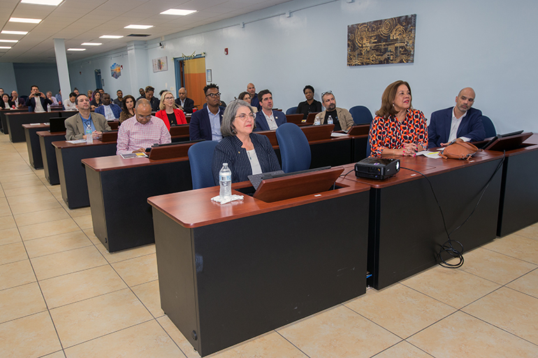 Guests and dignitaries, including Miami-Dade Mayor Daniella Levine Cava, front left, get to try out the facilities during opening ceremony for the Microsoft Accelerate Tech Lab at the Pierre Toussaint Leadership and Learning Center in Little Haiti, April 22, 2022.