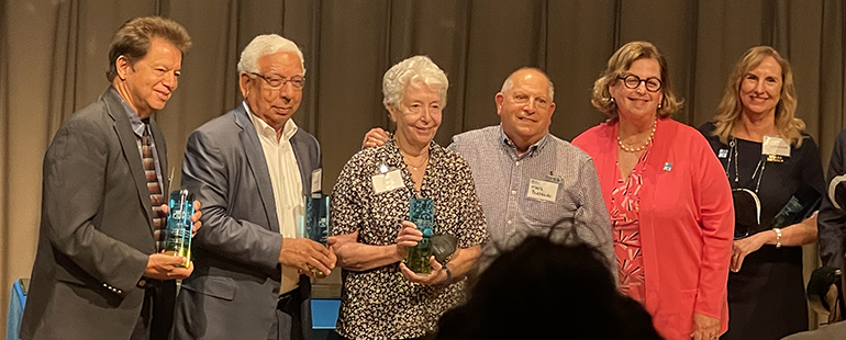 Peter Routsis-Arroyo, far left, CEO of Catholic Charities of the Archdiocese of Miami, poses along with other recipients of Jewish Community Services awards, May 25, 2022. Next to him, from left, are Khalid Mirza of the Coalition of South Florida Muslim Organizations; Margie and Mark Buchbinder of Temple Beth Am in Pinecrest; Miriam Singer, president and CEO of Jewish Community Services of South Florida; and Shelley Niceley Groff, JCS past chairwoman and representative of Temple Beth Sholom, Miami Beach. All were recognized as JCS Stars for their exemplary contributions in support of the JCS Surfside Response Initiative and its Refugee Assistance Program.