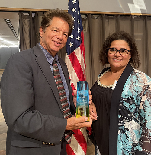 Peter Routsis-Arroyo, CEO of Catholic Charities of the Archdiocese of Miami, and Evelyn Soto, Catholic Charities program director, pose with the Star award given to Catholic Charities by Jewish Community Services on May 25, 2022. Soto "worked diligently throughout the Surfside building collapse to help coordinate our efforts," Routsis-Arroyo said.