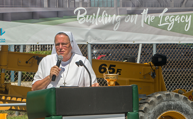 Salesian Sister Kim Keraitis, Immaculata-La Salle High School principal, addresses staff and students during the groundbreaking ceremony for a new athletic field and field house, June 1, 2022.