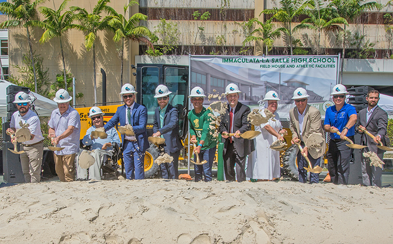 Doing the symbolic groundbreaking for a new athletic field and field house at Immaculata-La Salle High School, June 1, 2022, from left: Bill Evans, Florida Lemark Corporation; Luis Trelles, Trellis Cabarrocas Architects; Paul Callahan, vice chairman of the high school's board of directors and parent of ILS students; Nick Fernandez, athletic director; Gaston Arellano, class of '06 and director of Campus Operations; Miami Mayor Francis Suarez, '96; Jim Rigg, archdiocesan schools superintendent; Salesian Sister Kim Keraitis, principal; Ignacio Halley, '78, ILS board chairman; David Prada, archdiocesan director of Building and Property; and Eric Taggart, '07, ILS director of Vision and Design.