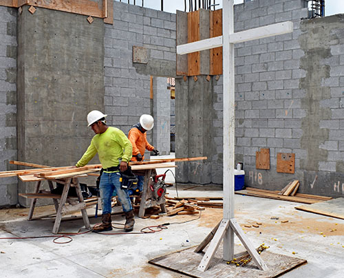 Workers prepare the chancel area of the new St. Agnes Church building, projected to host its first Mass in June 2023.