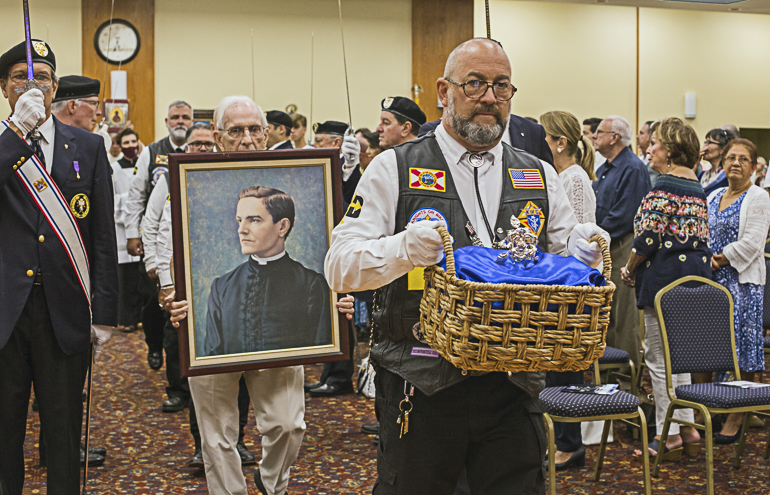 Knights on Bikes Florida member Juan Coro carries the Silver Rose into Mass at St. Hugh Church, Aug. 14, 2022, as John Steinbauer, former Grand Knight for Council 1726, carries the image of Blessed Father Michael McGivney, founder of the Knights of Columbus.
The stop at St. Hugh was part of the annual Silver Rose pilgrimage through the U.S. and Canada that the Knights on Bikes make to honor Our Lady of Guadalupe and promote the sanctity of human life.