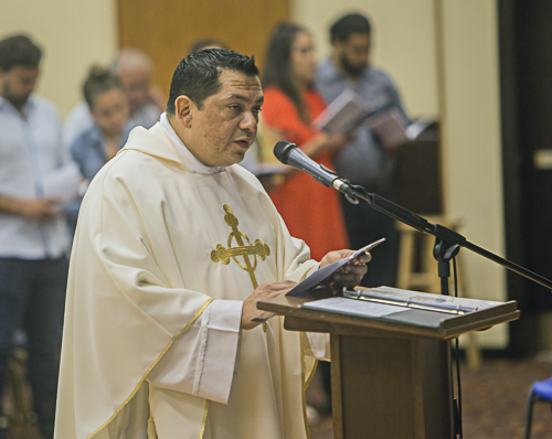 Father Luis Largaespada, pastor of St. Hugh in Coconut Grove, leads an act of consecration to conclude the prayer service Aug. 14, 2022, that marked the Silver Rose's stop at the parish.