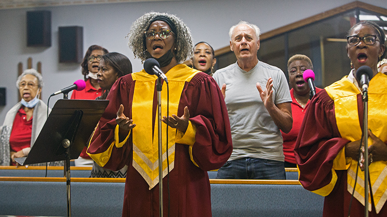 Ann Grant, a member of the choir at St. Helen Church, Lauderdale Lakes, helps lead the singing at the annual Unity Mass, celebrated by Archbishop Thomas Wenski, Aug. 21, 2022.