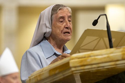 Claretian Sister Carmen Alvarez proclaims the first reading at the 25th anniversary Mass for her longtime friend, Archbishop Thomas Wenski, Sept. 3, 2022, at St. Mary Cathedral.