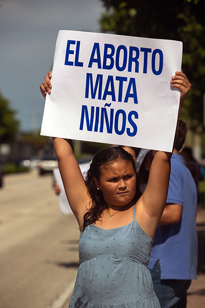 Anabella Duran, 10, a student at Our Lady of Lourdes in Kendall, holds up anti-abortion sign as she and others demonstrate against abortion along U.S. 1, from Kendall Drive to LeJeune Road, on Respect Life Sunday, Oct. 2, 2022.