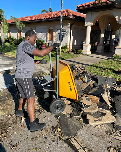 A worker cleans up some of the debris at Epiphany Cathedral School in Venice after the passage of Hurricane Ian, which ravaged parts of the southwest Florida diocese.