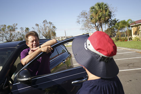 Peter Routsis-Arroyo, CEO of Catholic Charities of the Archdiocese of Miami, greets Catholic Charities staff and volunteers of the Diocese of Venice as he tours the hurricane damages and emergency distribution sites in Fort Myers, Oct. 5, 2022.