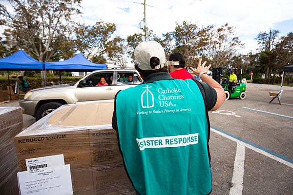 At a Catholic Charities site in Bonita Springs south of Fort Myers, staff and volunteers with Catholic Charities of the Diocese of Venice operate a drive-up emergency food and water distribution site following Hurricane Ian, Oct. 5, 2022.