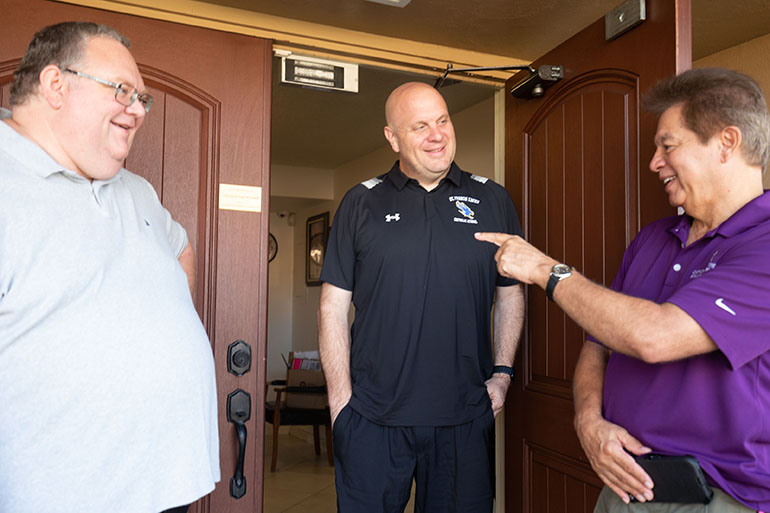 Father Anthony Hewitt, pastor of St. Francis Xavier in Fort Myers, left, meets with John Gulley, center, principal of St. Francis Xavier School, and Peter Routsis-Arroyo, CEO of Catholic Charities of the Archdiocese of Miami, who was visiting the area on Oct. 5, 2022 following the passage of Hurricane Ian.