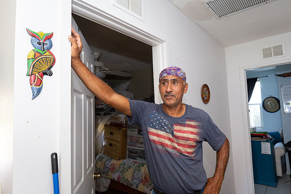 Luis Reyes, an employee of Catholic Charities of the Diocese of Venice, inspects damages to his home Oct. 5, 2022 in Fort Myers after Hurricane Ian brought at least three inches of rain into the residence.