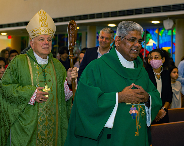 Archbishop Thomas Wenski and Father George Packuvettithara, St. Rose of Lima's pastor, enter the church for the Mass that kicked off the Miami Shores parish's 75th anniversary celebration, Oct. 9, 2022.