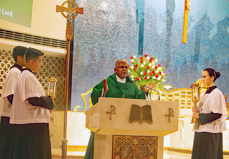Father George Packuvettithara, pastor, proclaims the Gospel at the Mass kicking off the 75th anniversary of St. Rose of Lima Parish in Miami Shores, Oct. 9, 2022.