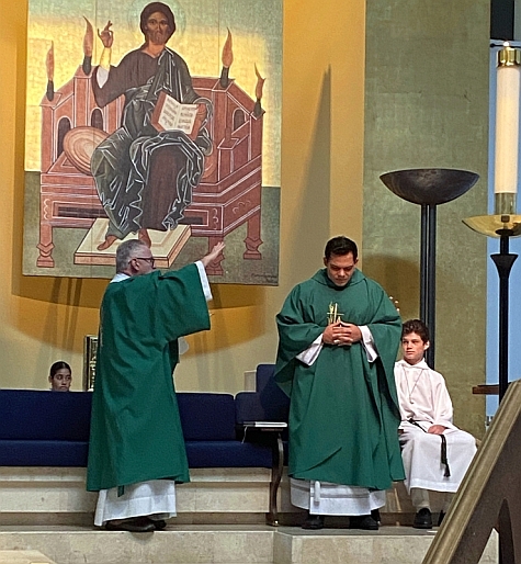 Deacon Felipe Gomez blesses Father Nicholas Toledo at St. John Neumann Catholic Church, Miami, as part of Priesthood Sunday promoted by Serra Club of Miami.