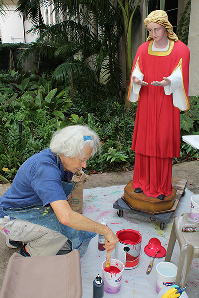 An angel awaits its finishing touches by artist and parishioner Kathleen Staples in an outdoor studio area between Little Flower Church and Comber Hall in Coral Gables. Staples repainted outdoor Nativity scene statues that were in need of a vibrant touch up just in time for Advent 2022.