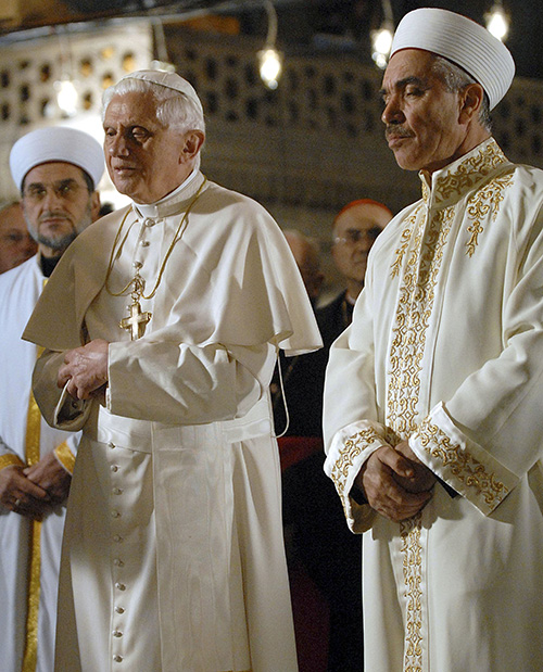 Pope Benedict XVI prays next to Mustafa Cagrici, the grand mufti of Istanbul, and other Muslim clerics as he visits the Blue Mosque in Istanbul Nov. 30, 2006. The pope's unexpected prayer in the mosque soothed anger in the Muslim world over a quote about Islam in his Sept. 12, 2006, lecture in Regensburg, Germany. (CNS photo/Anatolian News Agency/Salih Zeki Fazlioglu)