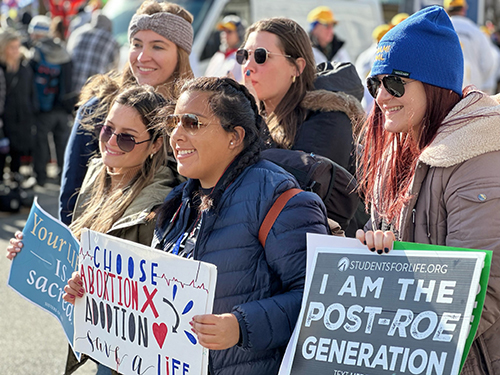 Isabel Rennella, center, joins over 90 young people from Miami at the first post-Roe March for Life, traveling to Washington, D.C., Jan. 18-21, 2023. The pilgrimage was led by Stephen Colella, director of the Office of Parish Life, and Father Manny Alvarez, pastor of the Church of the Little Flower in Coral Gables.