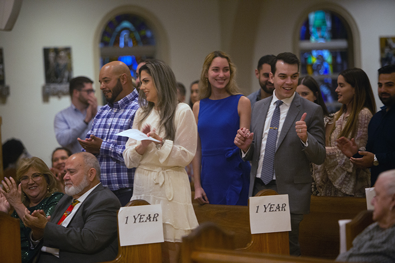 Jesus Valentino, far right, married to Mariela Valentino, next to him, for one year, gives a thumbs up to those couples celebrating more than 50 years of marriage, as couples are recognized during the annual Mass celebrating sacramental marriage. The Mass was celebrated by Archbishop Thomas Wenski Feb. 18, 2023 at St. Mary Cathedral in Miami.