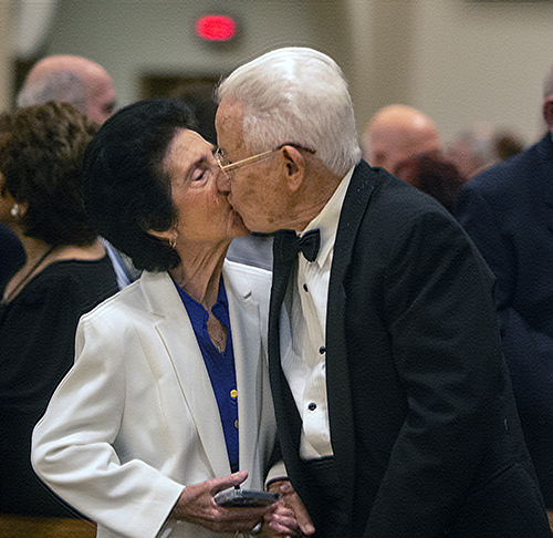 Elvira and Ernesto Frias of St. Agnes Parish in Key Biscayne, married 60 years, kiss during the annual Mass honoring sacramental marriage and couples celebrating milestone anniversaries. The Mass was celebrated by Archbishop Thomas Wenski Feb. 18, 2023 at St. Mary Cathedral in Miami.