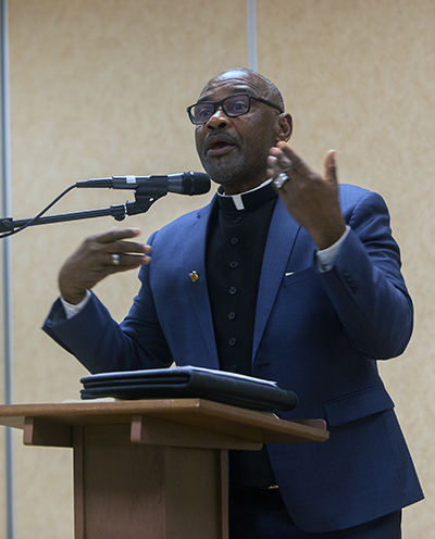 Father Robes Charles, pastor of Sacred Heart Parish in Homestead, addresses participants at a workshop on Catholic social teaching, held Feb. 20, 2023 at St. Mary Cathedral. Archbishop Thomas Wenski and other priests led the workshop for speakers of English, Spanish and Haitian Creole.