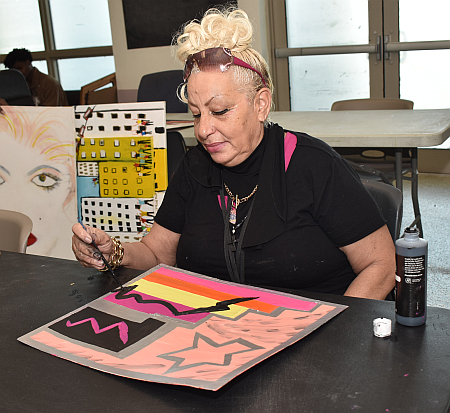Martha Cruz favors broad strokes and bold colors in the art therapy program at Camillus House.